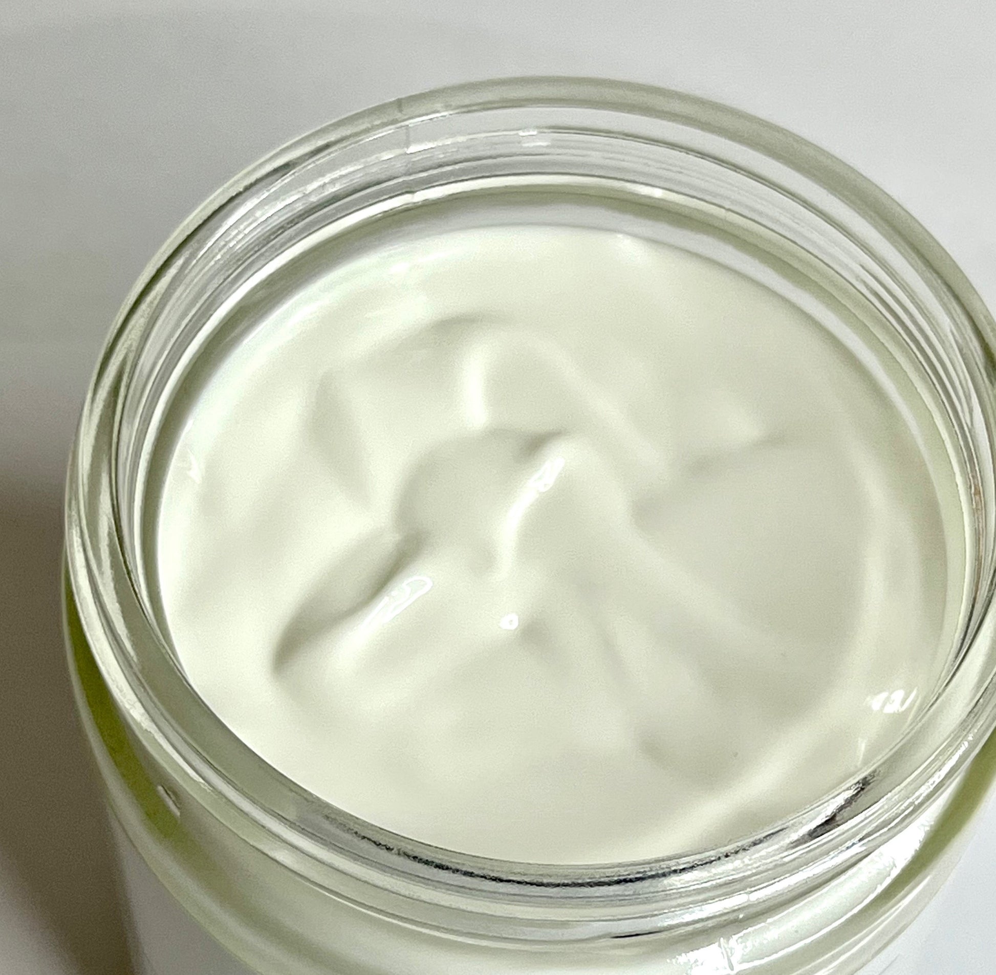 Luxurious Vanilla Bean Moisturizing Body Cream in an open jar showing its creamy texture and rich, hydrating formula.